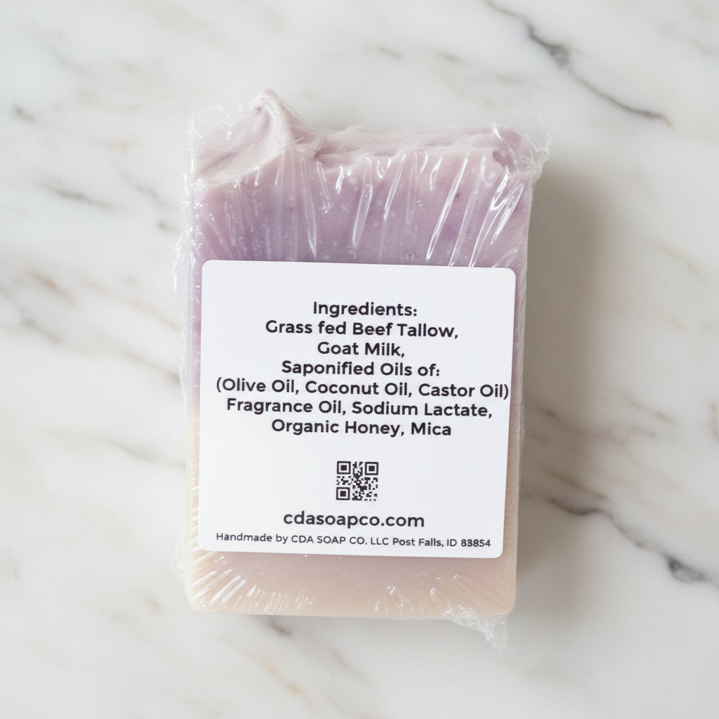 Bar of soap with a label detailing ingredients on a white marble background