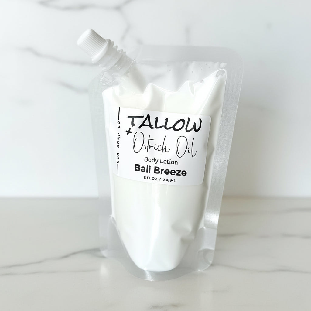 Body lotion pouch labeled 'Tallow + Ostrich Oil Bali Breeze' on amarble surface.