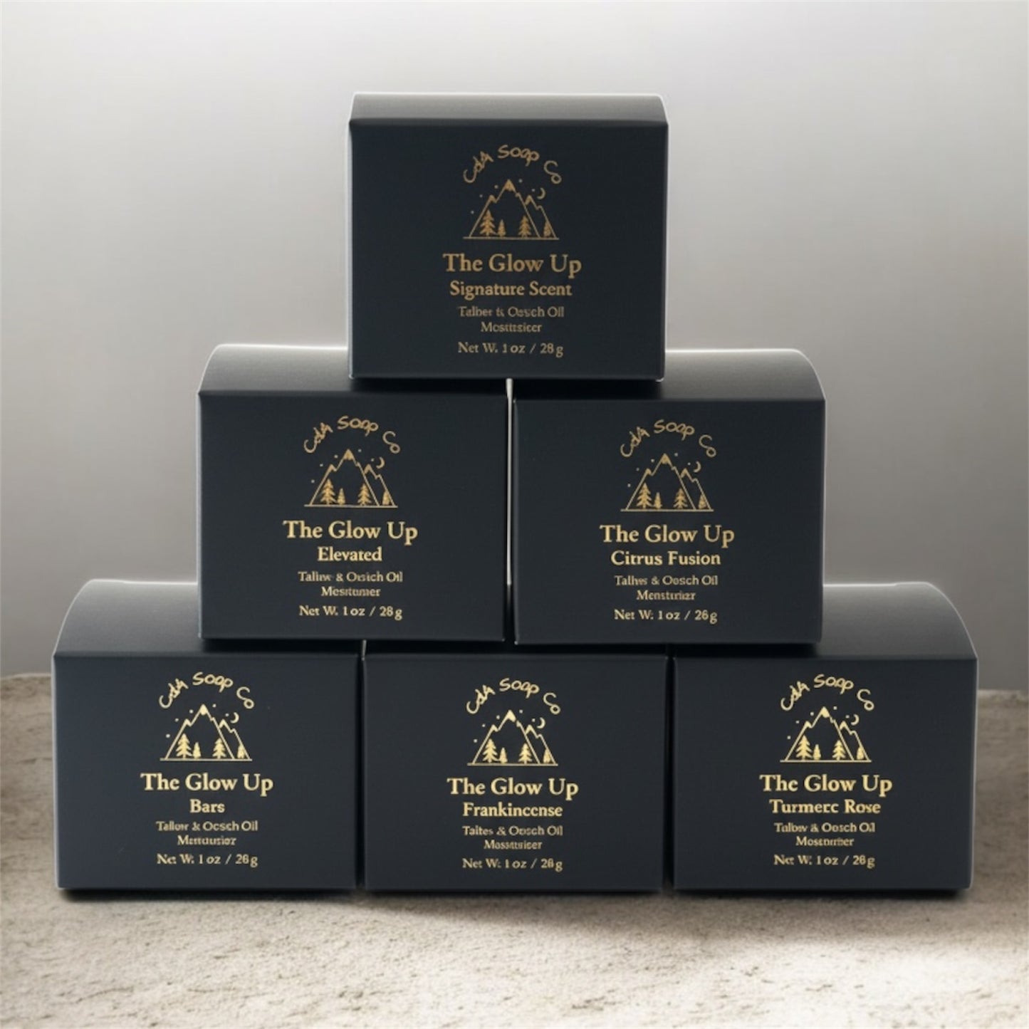 Stack of black face moisturizer boxes with 'The Glow Up' branding on a gray background