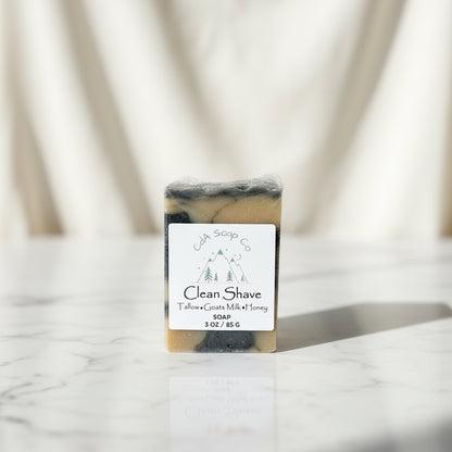 Bar of “clean shave” soap with a label on a marble surface