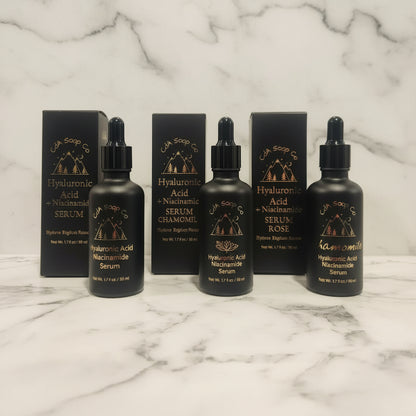 Black serum bottles with droppers and boxes on a marble surface with marble background