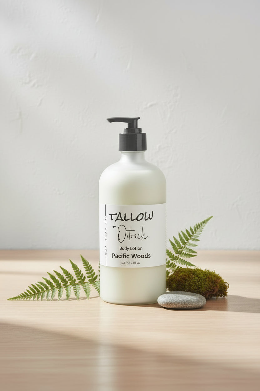 Bottle of Tallow + Ostrich body lotion labeled 'Pacific Woods' on a wooden surface