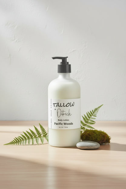 Bottle of Tallow + Ostrich body lotion labeled 'Pacific Woods' on a wooden surface