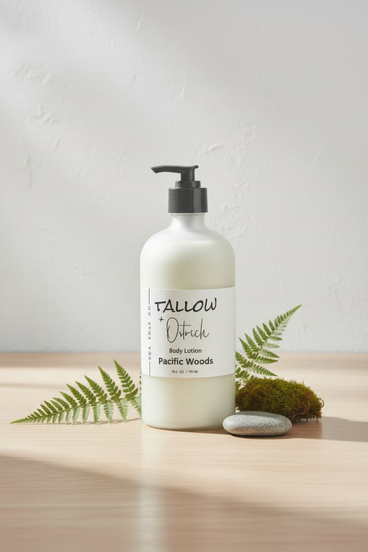 Bottle of Tallow + Ostrich body lotion labeled 'Pacific Woods' on a wooden surface
