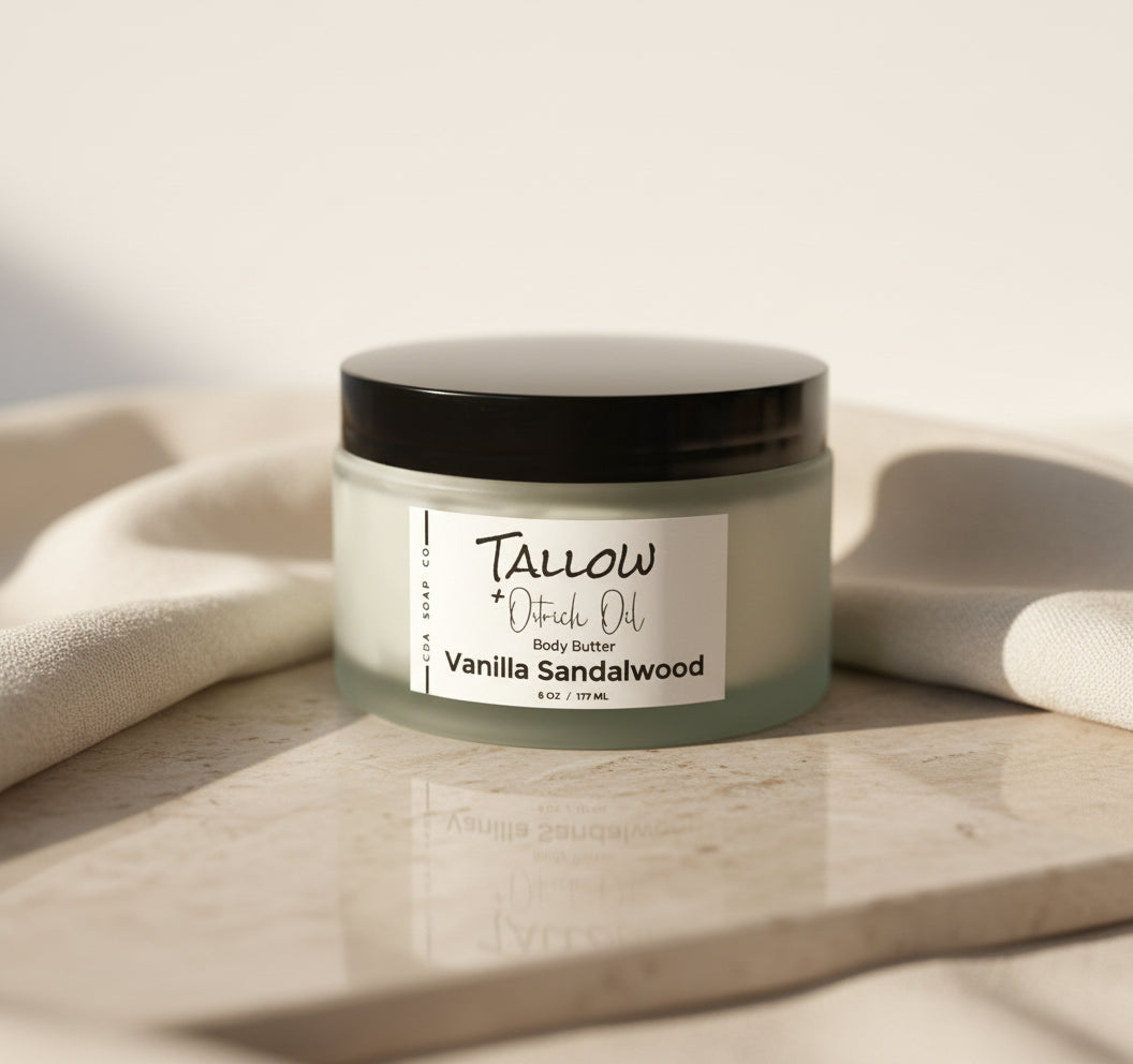 Jar of Tallow + Ostrich Oil Vanilla Sandalwood body butter on a wooden surface with a neutral background