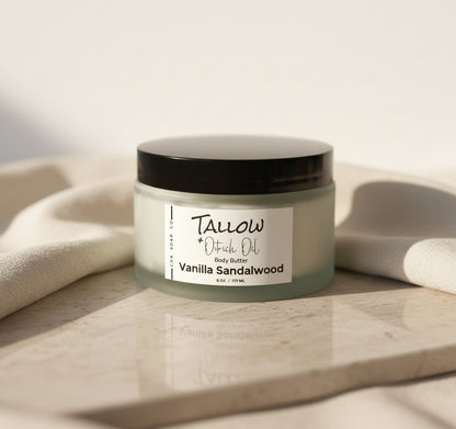 Jar of Tallow + Ostrich Oil Vanilla Sandalwood body butter on a wooden surface with a neutral background