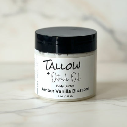 jar of tallow body butter on marble surface
