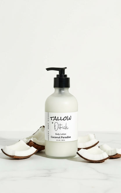 Body lotion bottle with pump and coconut pieces on a white background