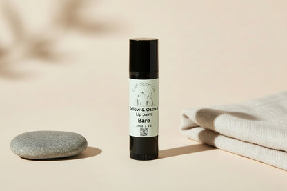 Plastic lip balm container with black caps and white labels featuring Mountain graphics on a white background. Label reads CdA Soap Co. Tallow & Ostrich Lip Balm. Bare. For unscented/ unflavored. Weight 5 g