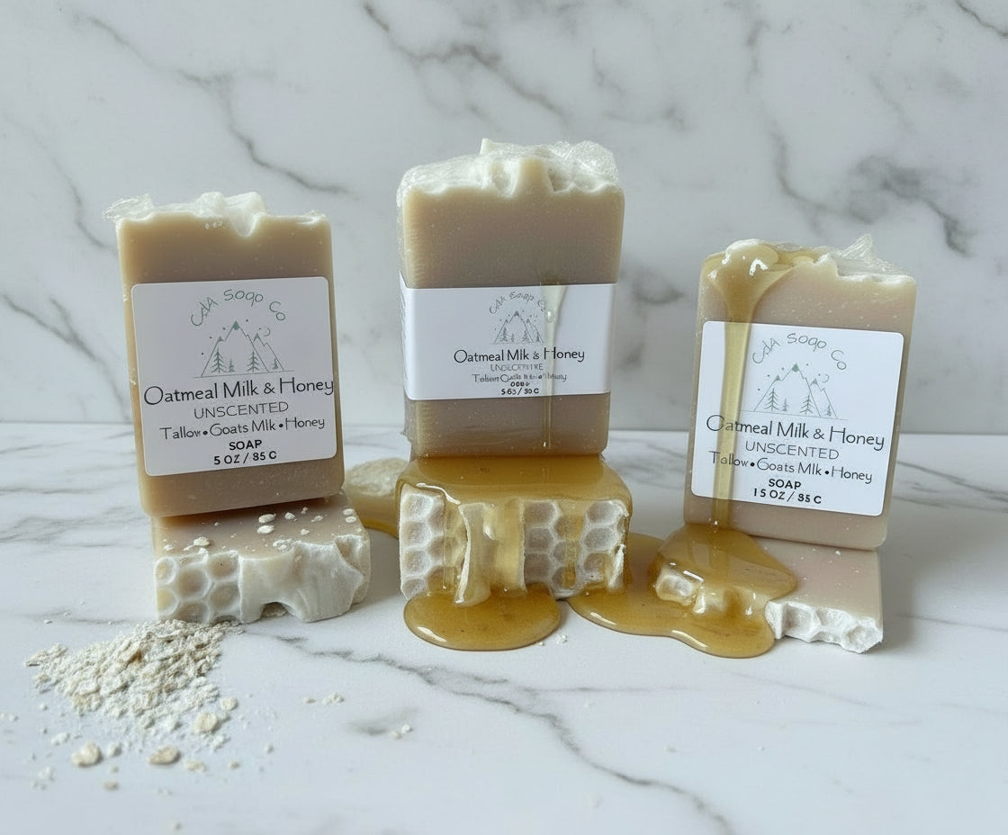 Three bars of soap with honeycomb and oats on a wooden surface, featuring 'Oatmeal Milk & Honey' branding.