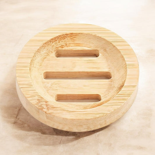 round light round soap dish with 3 drainage slots on a light marble background