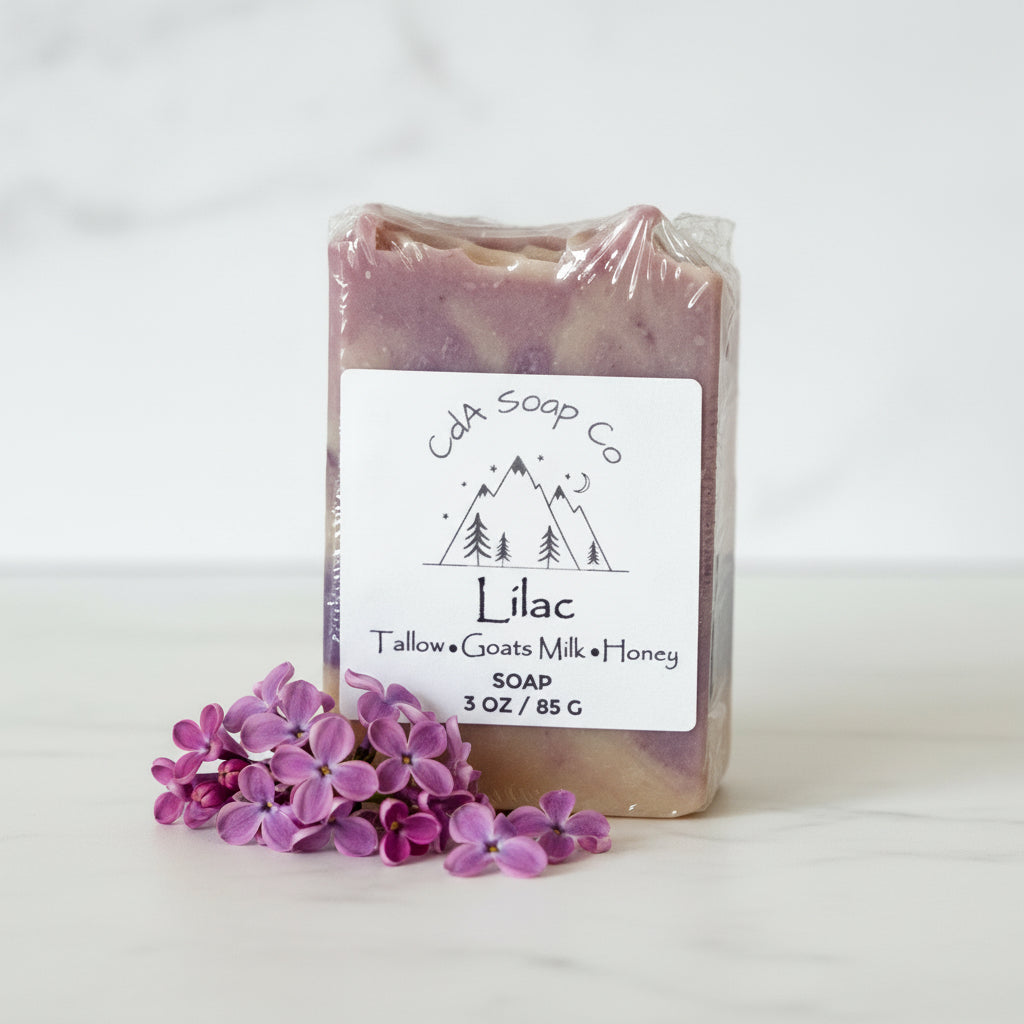 Bar of soap with a 'Lilac' label and small purple flowers on a white background