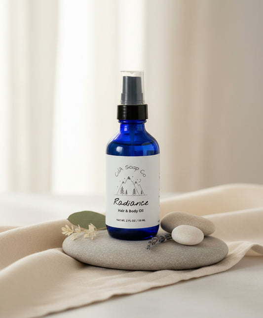 Blue bottle with white label on a stack of gray stones on a beige surface