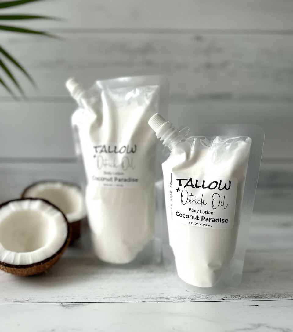 Two bottles of Tallow + Ostrich Oil body lotion with coconuts on a wooden surface.