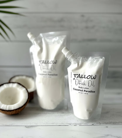 Two bottles of Tallow + Ostrich Oil body lotion with coconuts on a wooden surface.