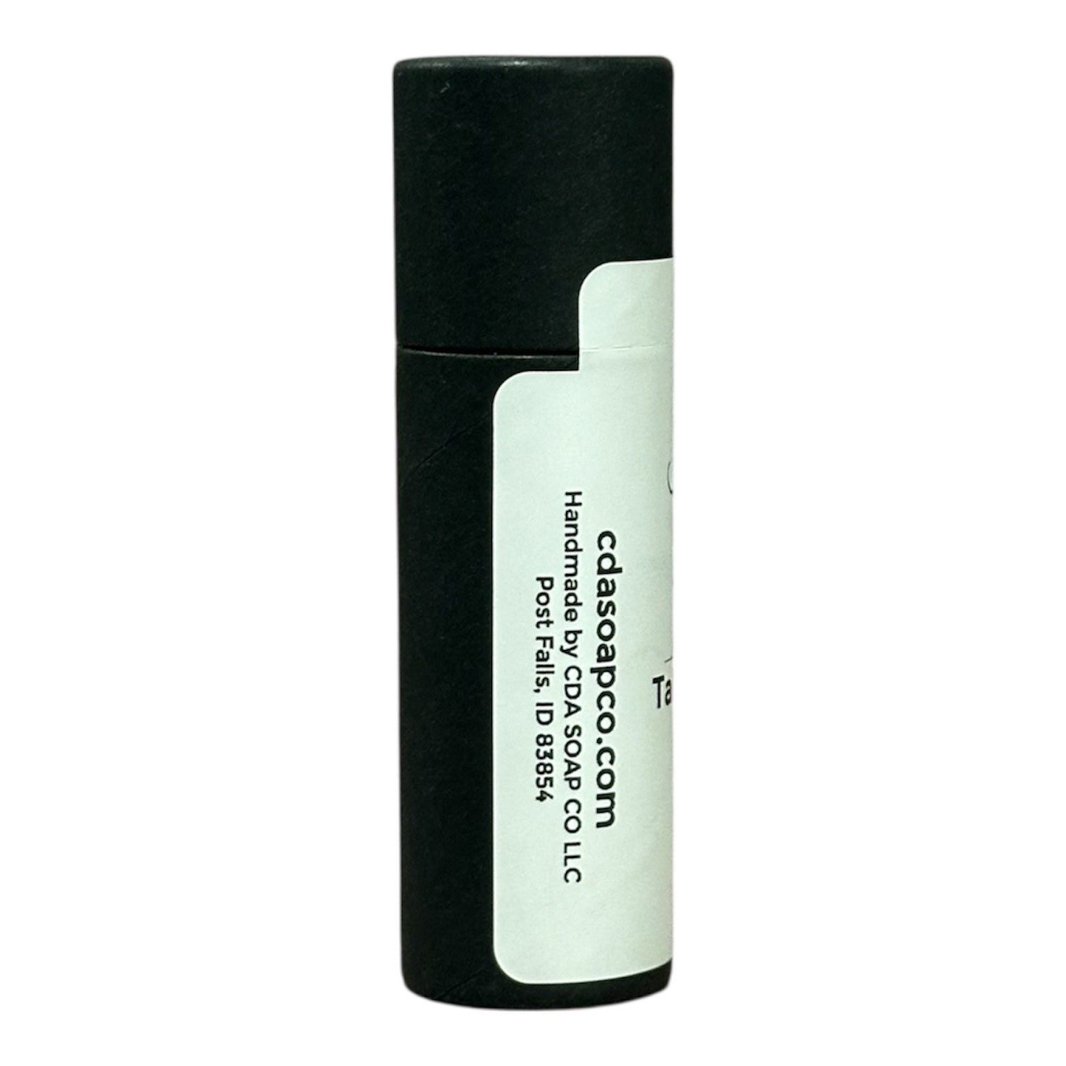 Side view of black Kraft lip balm tube with white label and black text showing the website address and handmade by CdA soap co llc in post falls ID 83854