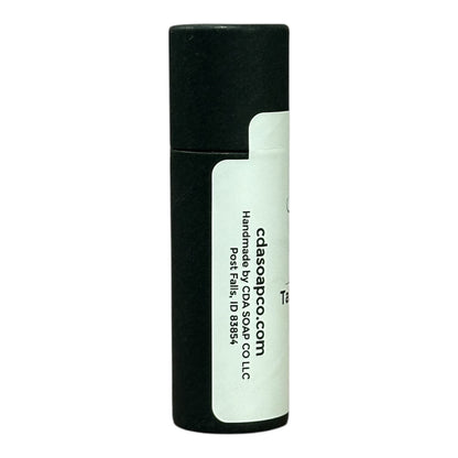 Side view of black Kraft lip balm tube with white label and black text showing the website address and handmade by CdA soap co llc in post falls ID 83854
