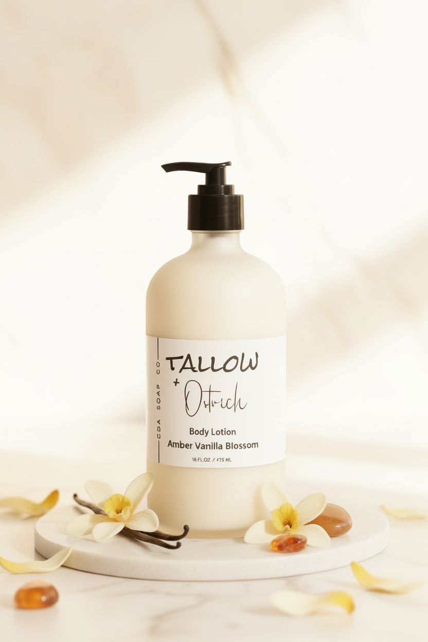 Body lotion bottle labeled 'Tallow & Oatmeal' on a decorative stand with vanilla beans and flowers.