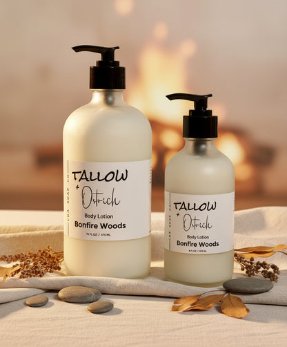 Two bottles of Bonfire Woods Tallow & Ostrich body lotion on a neutral background with decorative elements.