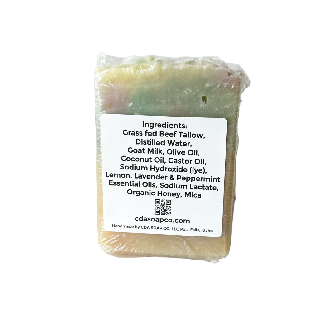 Bar of soap with a label detailing ingredients on a white background