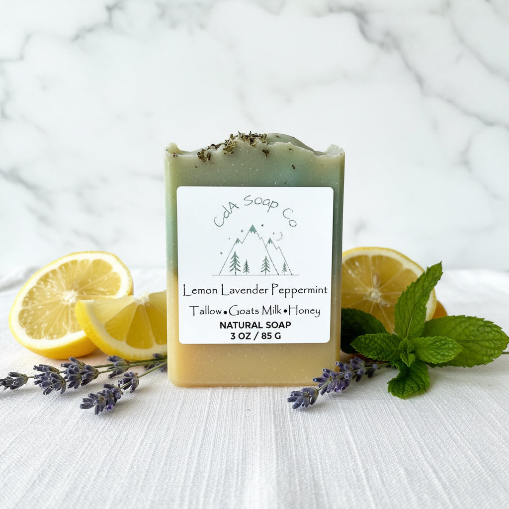 Bar of soap with a label surrounded by lemon slices, lavender flowers, and mint leaves on a marble background