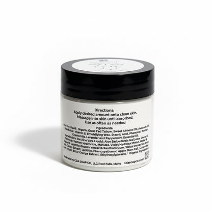 Jar of cream with black lid and white label on a white background