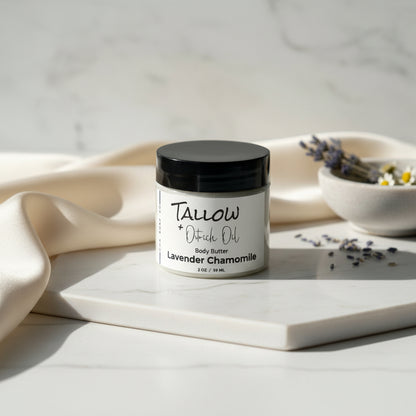 Jar of lavender chamomile body butter with a black lid on a gray surface.