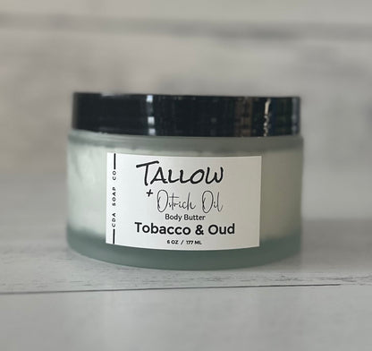 Jar of Tallow + Ostrich Oil body butter labeled 'Tobacco & Oud' on a neutral background