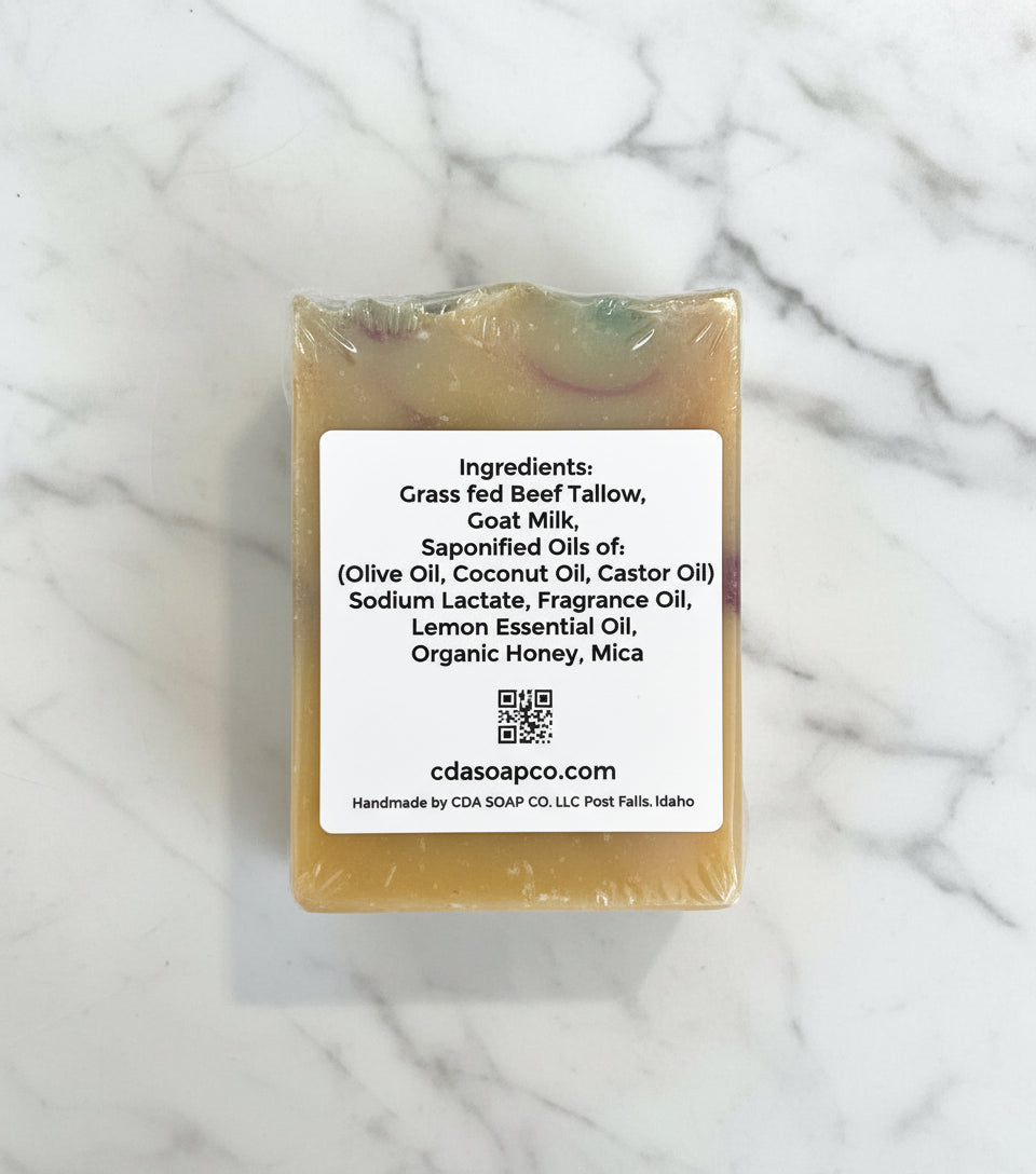 Bar of soap with a label detailing ingredients on a white background