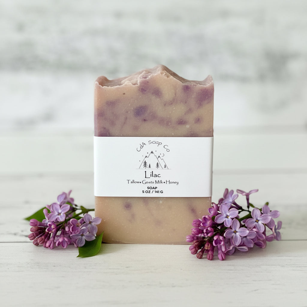 Bar of soap with a label and lilac flowers on a wooden surface