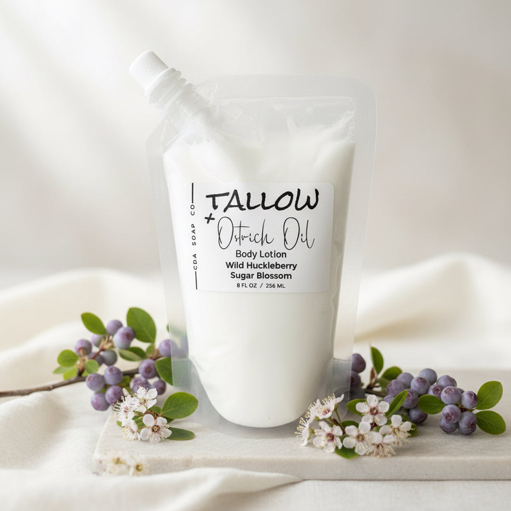 Wild huckleberry sugar blossom Tallow Ostrich Oil body lotion packaging on a wooden surface