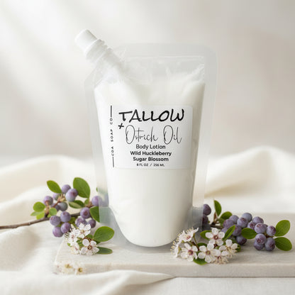 Wild huckleberry sugar blossom Tallow Ostrich Oil body lotion packaging on a wooden surface