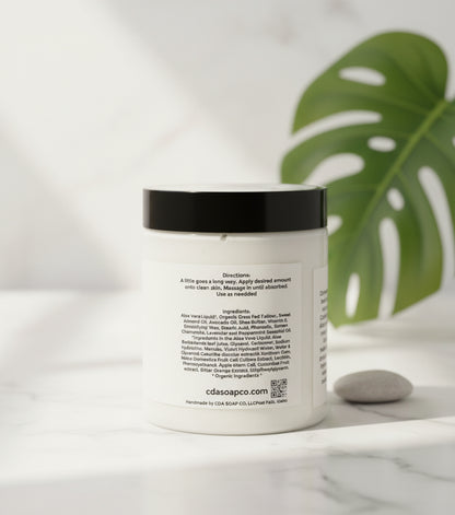 Jar of Aloe Tallow cream with a label on a wooden surface