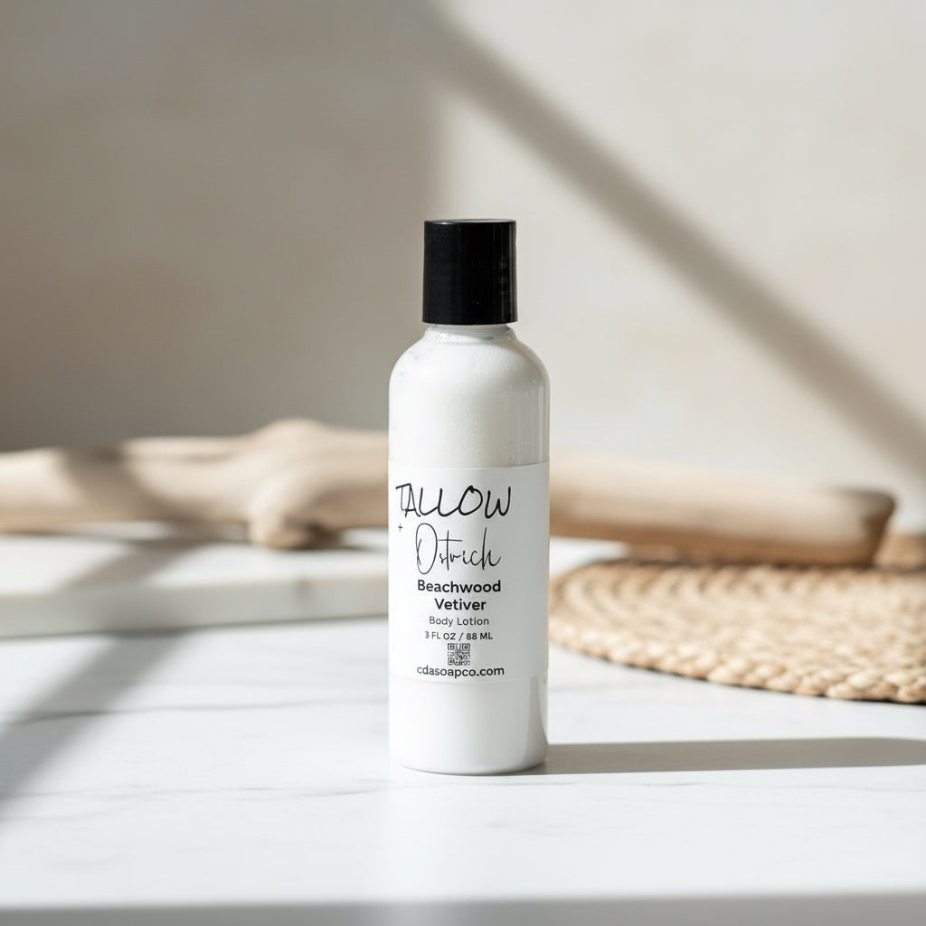 White bottle of 'tallow' body lotion on a light surface with a neutral background