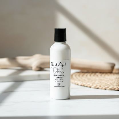 White bottle of 'tallow' body lotion on a light surface with a neutral background