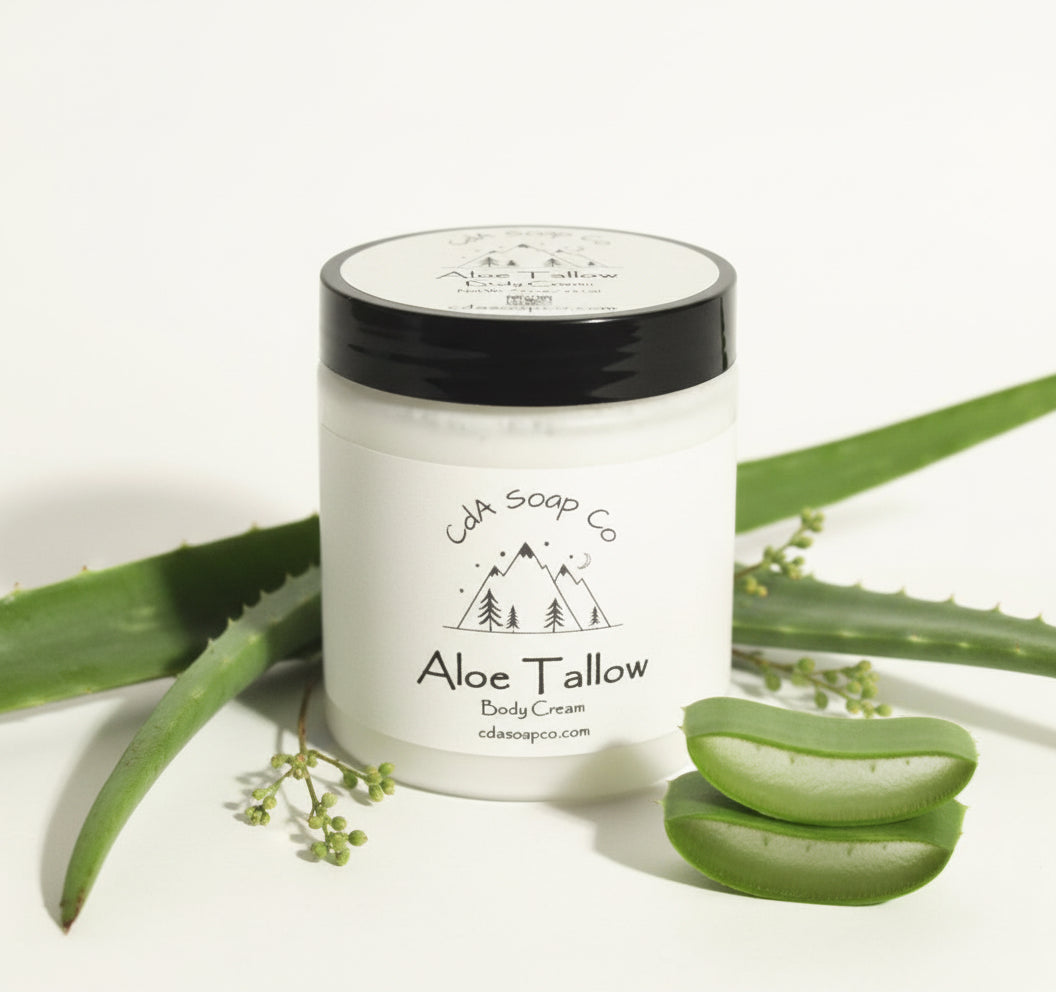 Aloe Tallow body cream jar with aloe vera leaves on a white background