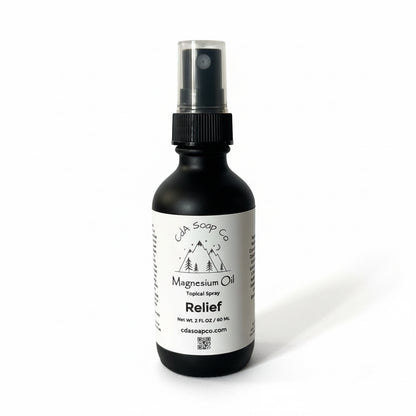Black spray bottle labeled 'CdA  Soap Co Magnesium Oil Relief' on a white background