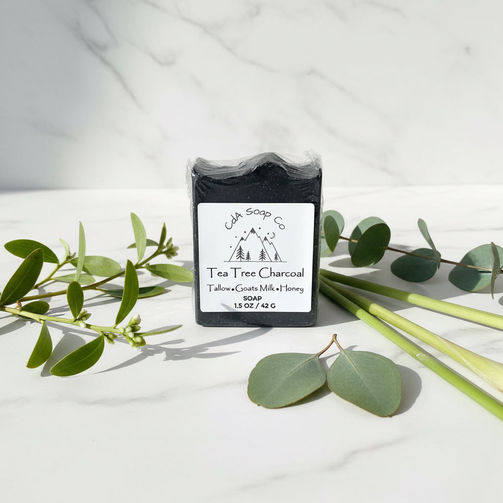 Tea Tree Charcoal soap bar in packaging on a wooden surface