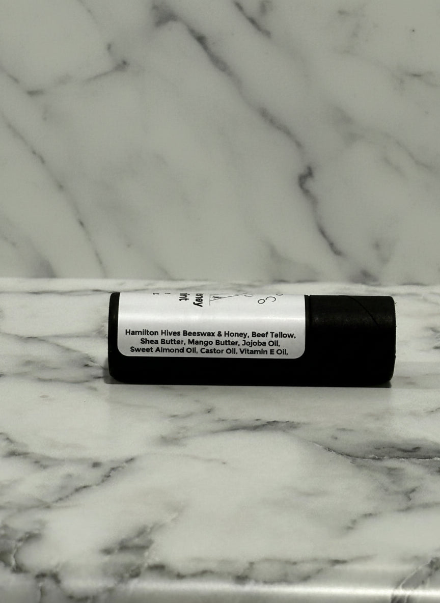 kraft board tube of lip balm with a label on a marble surface