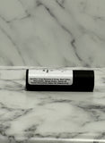 kraft board tube of lip balm with a label on a marble surface