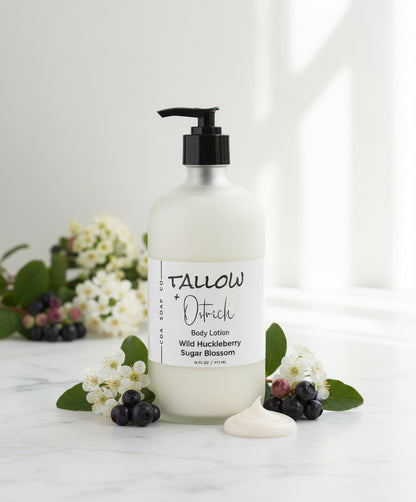 Body lotion bottle with a label on a white surface with flowers and berries.
