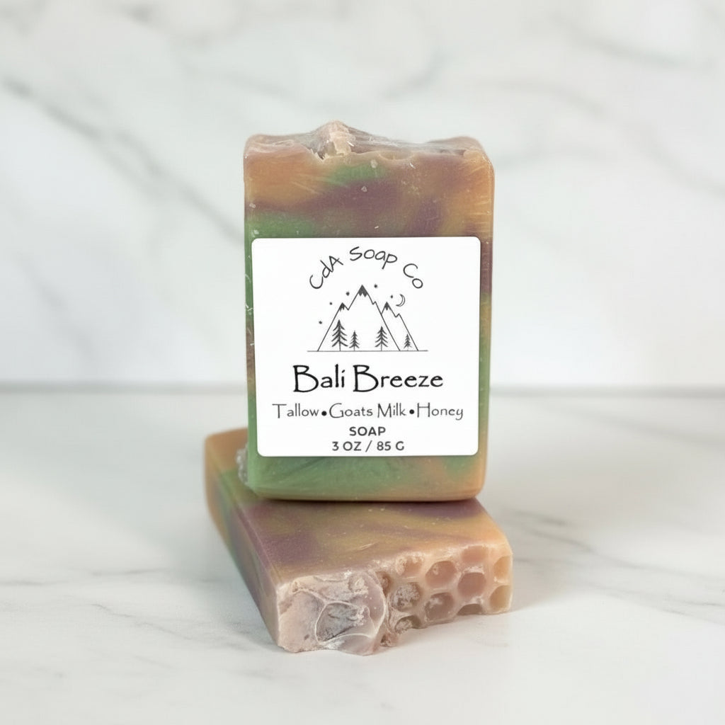 Two soap bars with a visible label on a light surface