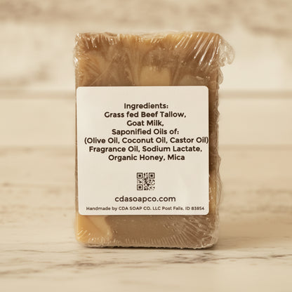 Bar of soap with a label detailing ingredients on a wooden surface