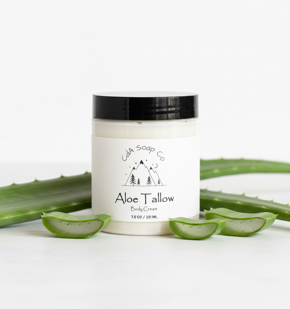 Aloe Tallow body cream jar with aloe vera leaves on a white background