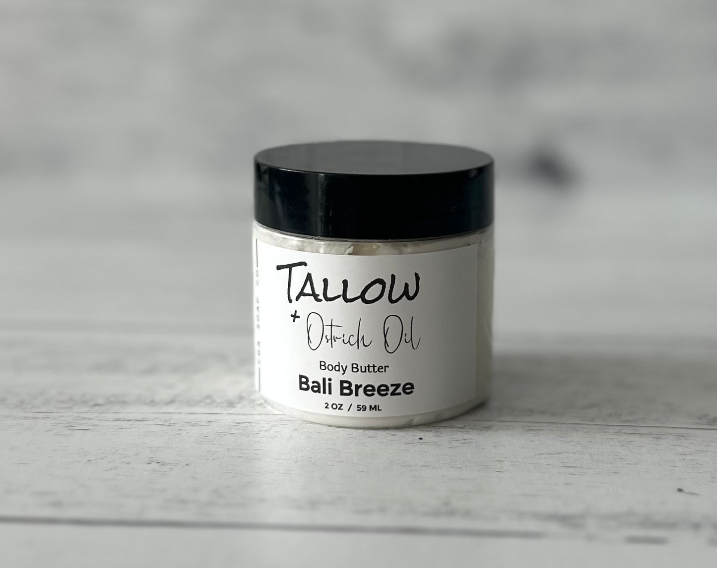 Small Jar of Tallow + ostrich Oil Body Butter on a wooden surface
