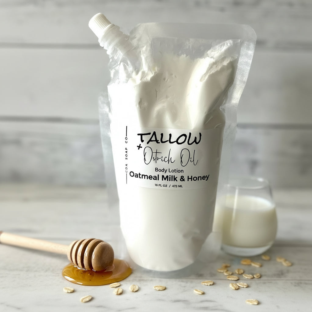 Body lotion bag labeled 'Tallow' with a glass of milk and honey dipper on a marble surface.