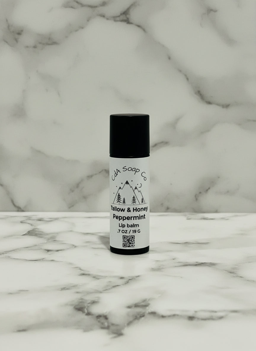 kraft board tube of lip balm on a textured surface with a marble pattern