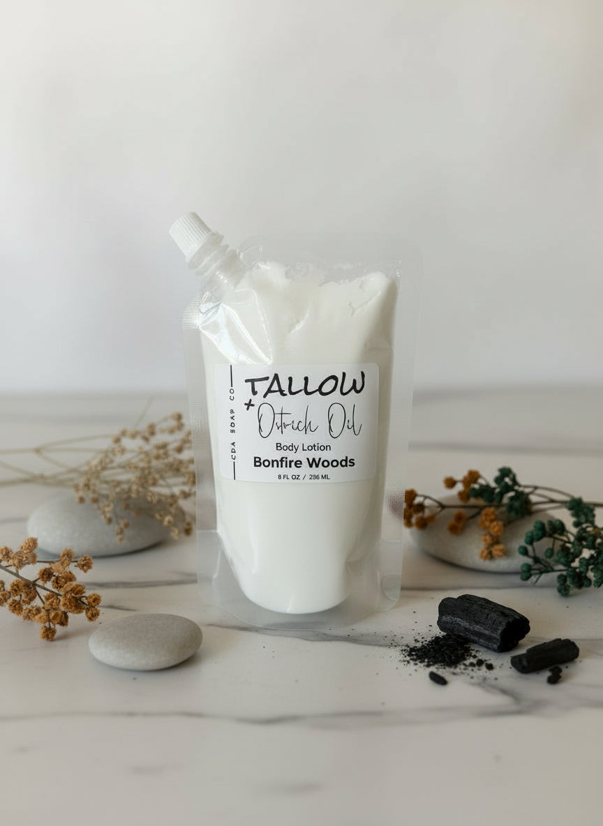 Tallow body lotion in plastic pouch packaging on a white surface with decorative elements