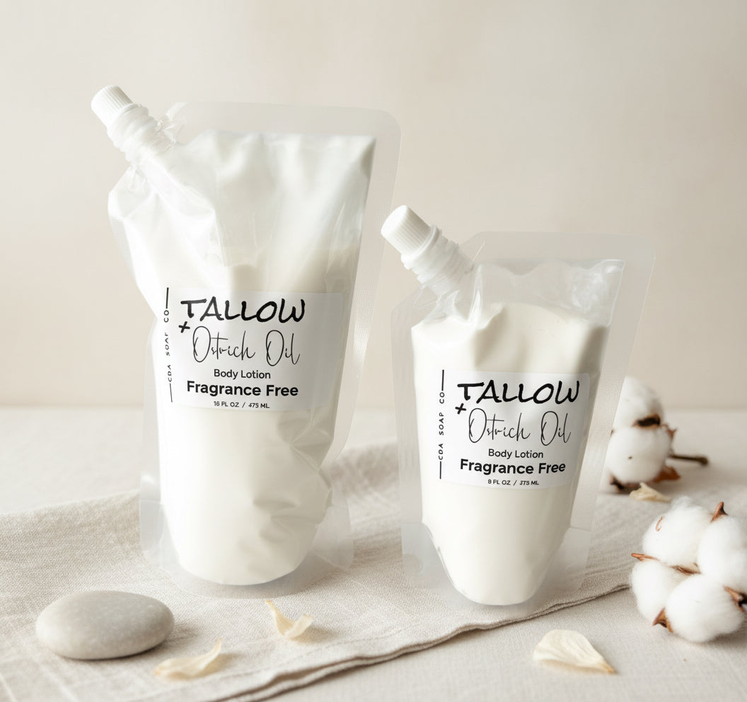 Two pouches of Tallow & Ostrich Oil lotion on a neutral background with cotton flowers.