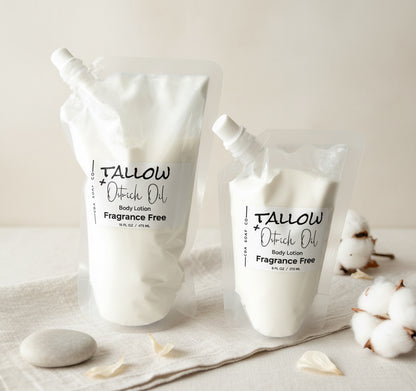 Two pouches of Tallow & Ostrich Oil lotion on a neutral background with cotton flowers.